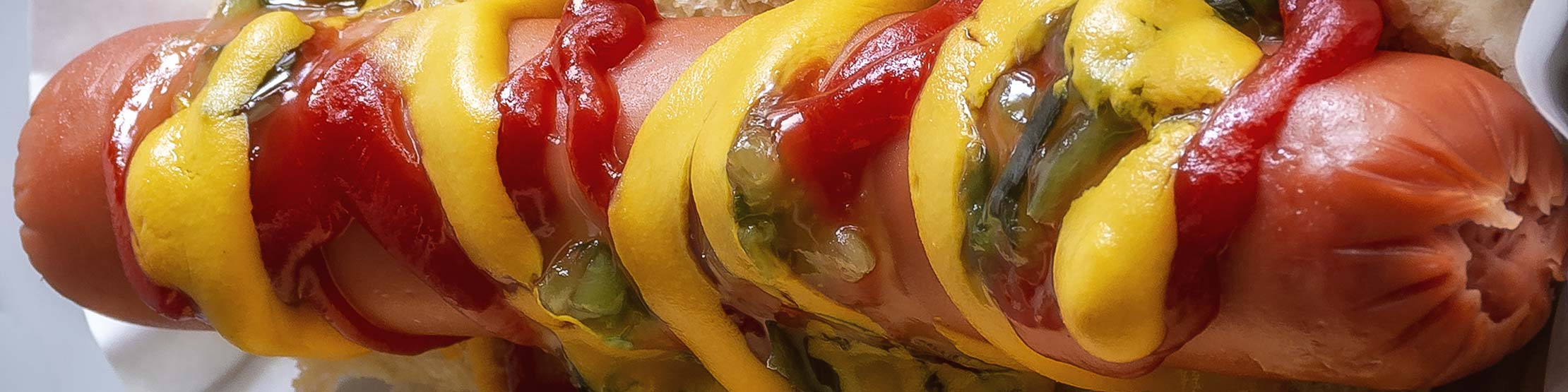 Single hot dog, loaded, by David Thielan via Unsplash